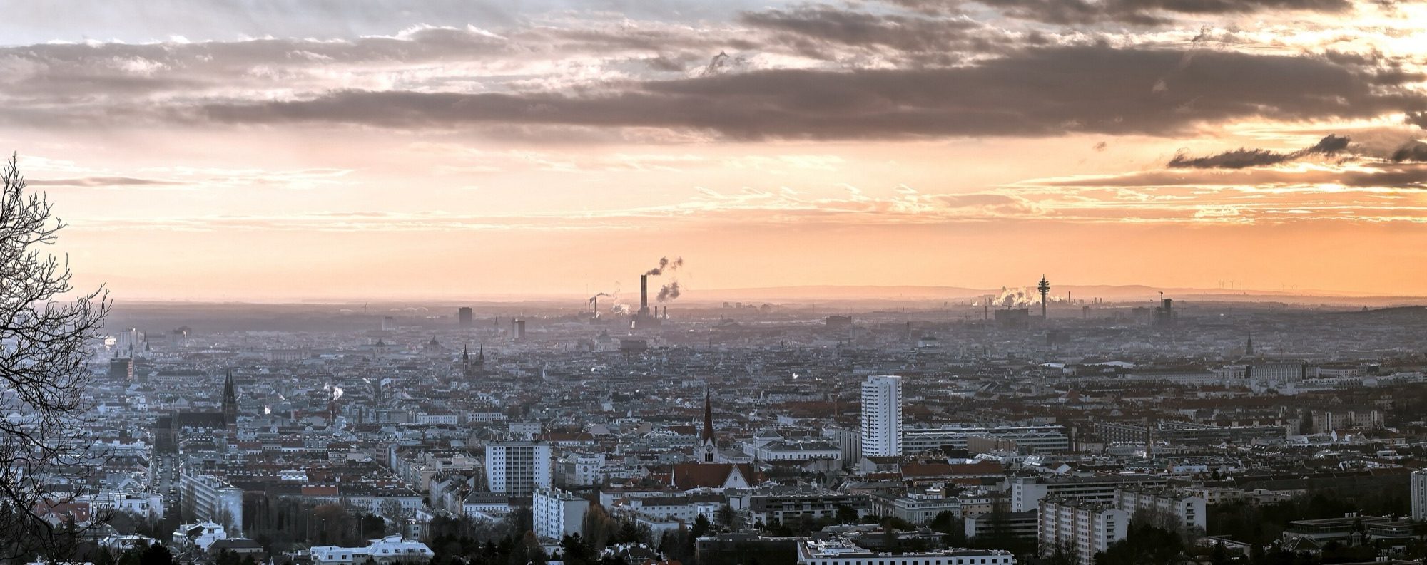 Vienna's Danube City skyline reflected in still water at sunset, the Donauturm on the right