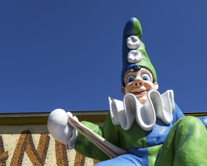 The brightly painted Calafati figure at the Wurstelprater funfair against a blue sky