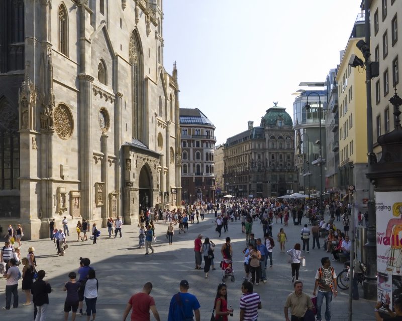 St Stephen's Cathedral rising over a busy Stephansplatz, with visitors crossing the square
