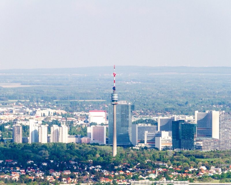 The Donauturm rising over the towers and rooftops of Vienna's Donaustadt