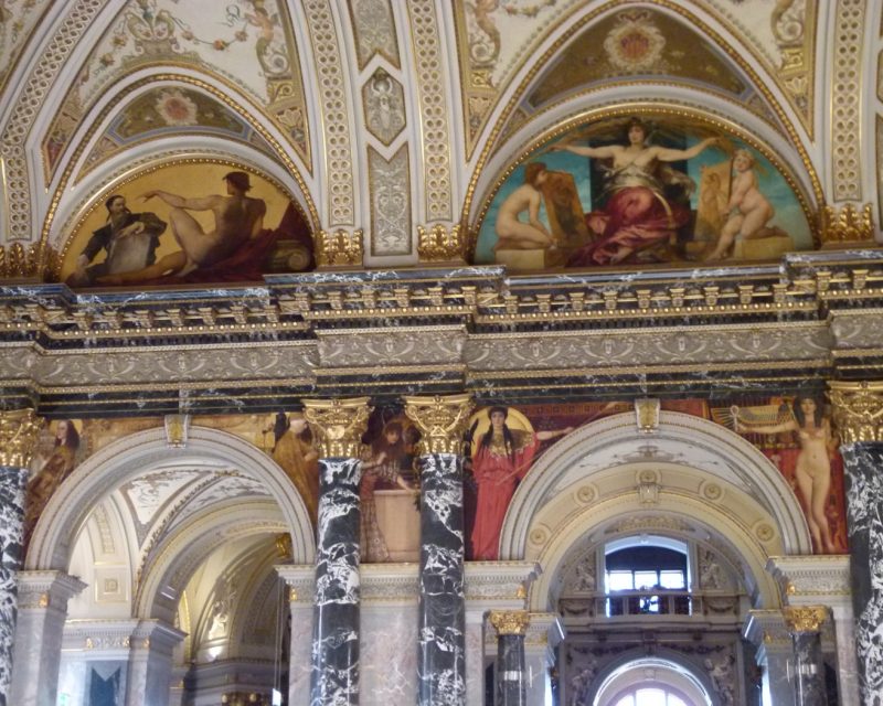Frescoed arches and marble columns above the Kunsthistorisches Museum's grand staircase