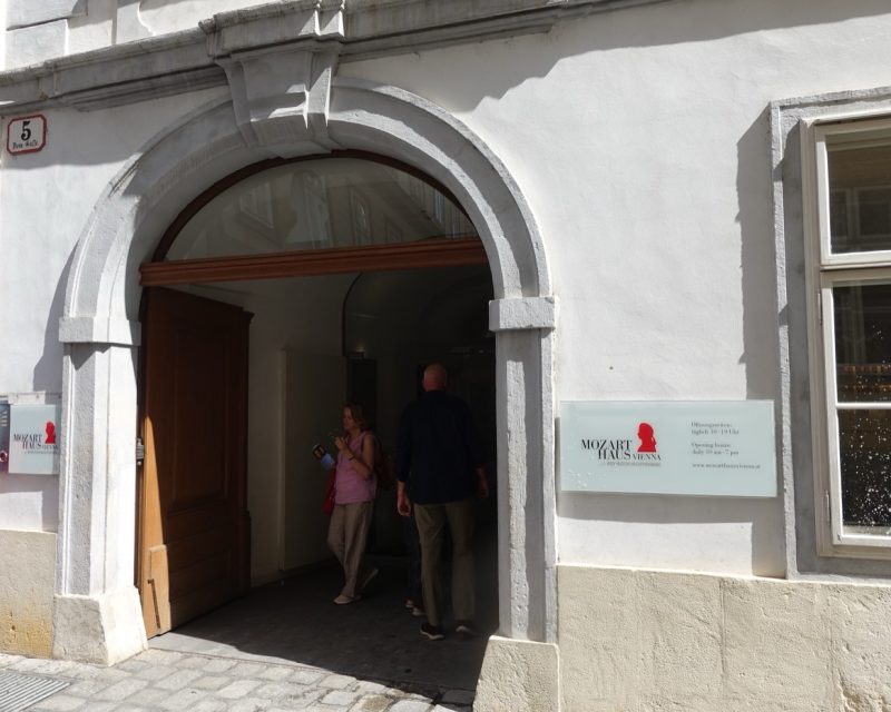 The entrance archway of Mozarthaus Vienna, with visitors going in