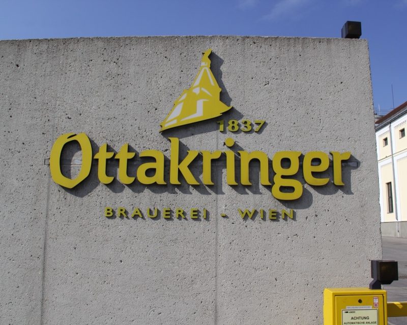 The Ottakringer brewery sign, gold lettering on a concrete wall, dated 1837