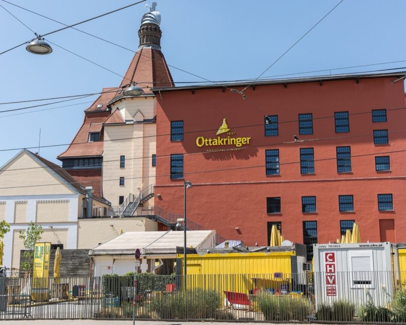 The brewery's red malt house and turreted brewhouse seen from the street