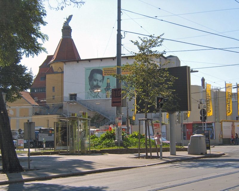 The Ottakringer brewery gate on Ottakringer Strasse, yellow banners along the street