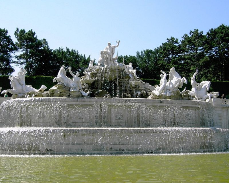 The Neptune Fountain below Schönbrunn's hill, its stone sea gods spraying water