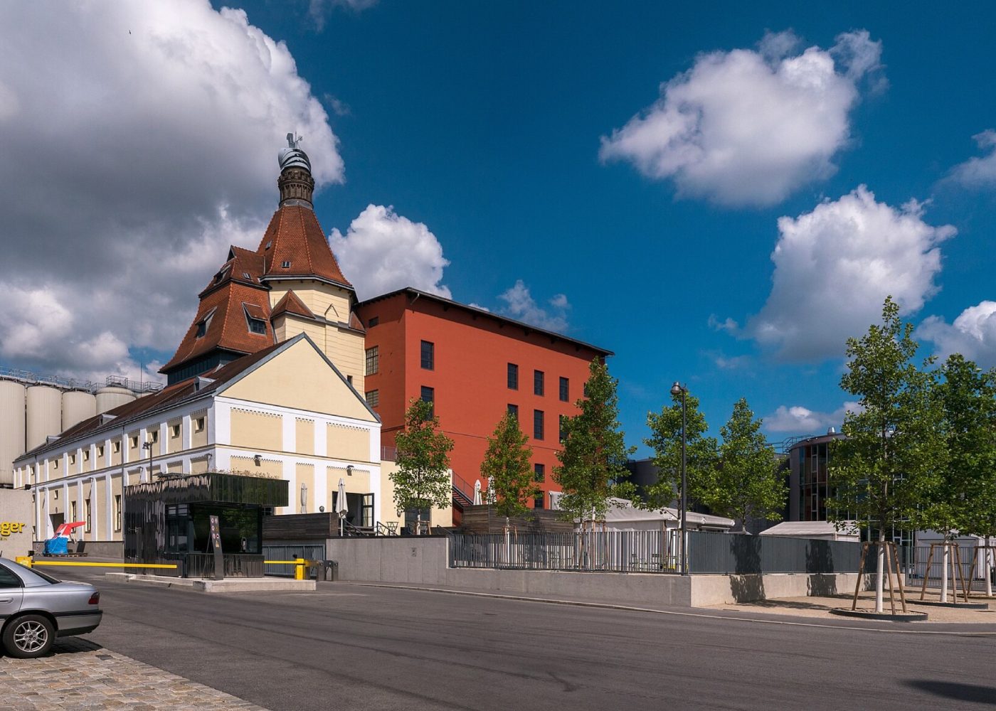 The Ottakringer brewery in Vienna: its turreted brewhouse, red malt store and steel fermentation tanks under a blue sky